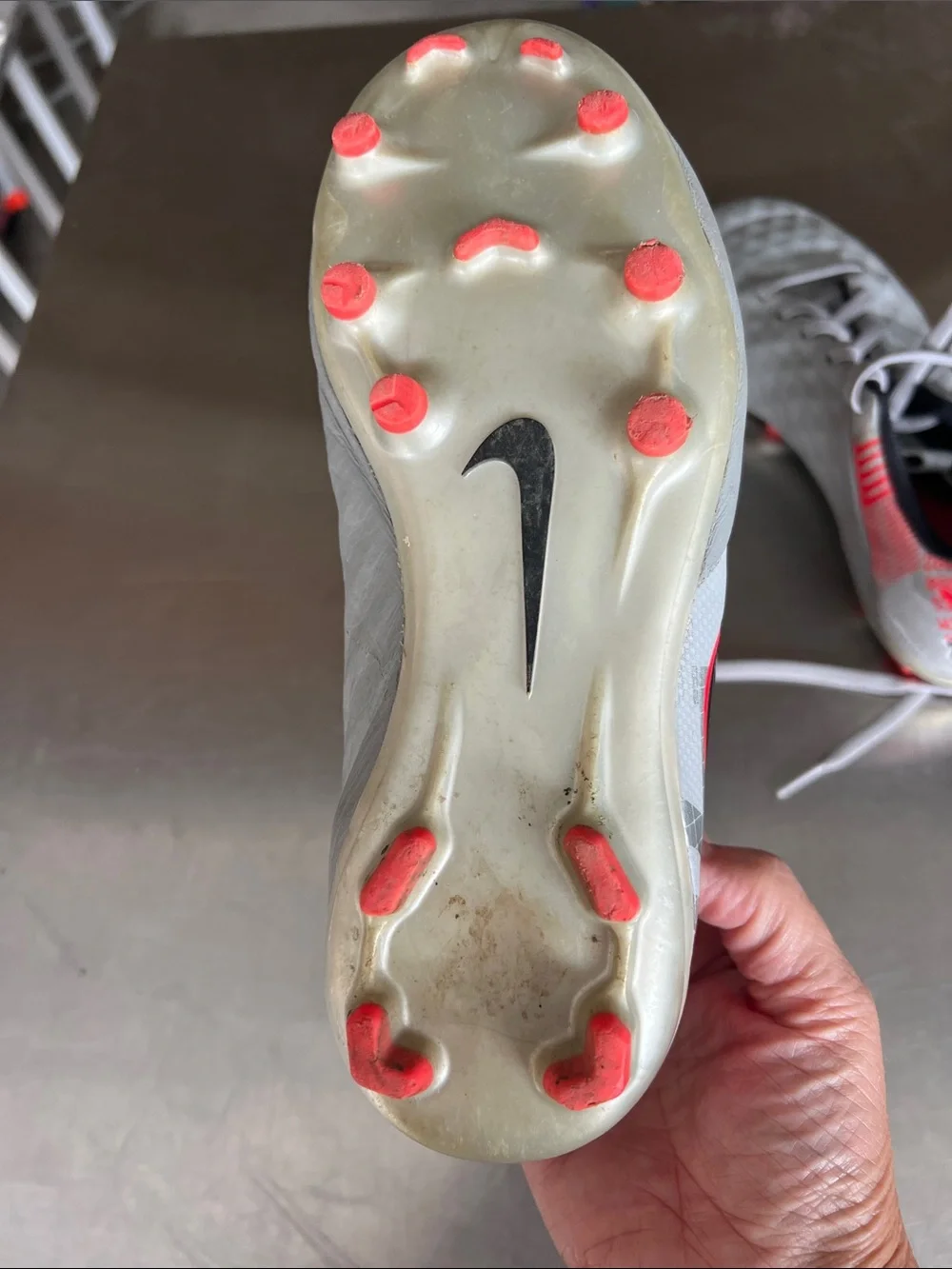 Nike Youth Gray Soccer Cleats with Black Swoosh and Pink-Red Accents